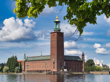 Tower of building against cloudy sky