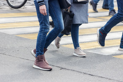 Low section of people walking on road