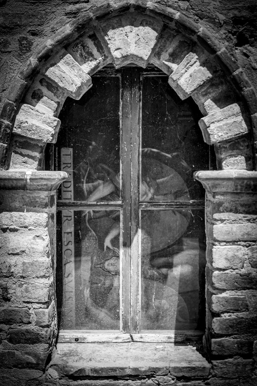 REFLECTION OF OLD BUILDING ON WINDOW