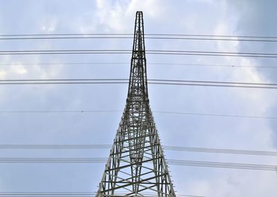 Low angle view of electricity pylon against sky