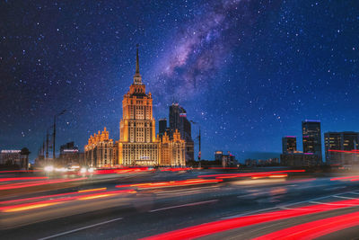 Light trails on road against buildings at night. hotel ukraina