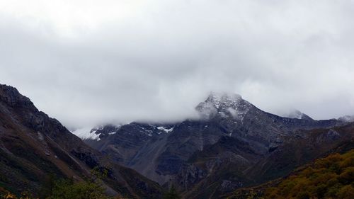 Scenic view of mountains against cloudy sky