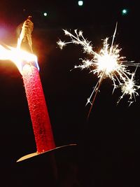 Low angle view of illuminated lights at night