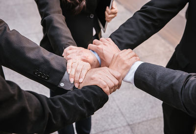 High angle view of business people forming hand chain