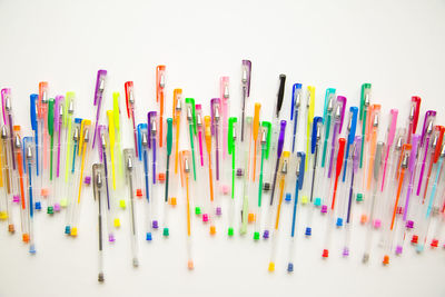 Close-up of colored pencils over white background