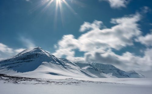 Scenic view of snowcapped mountains against sky