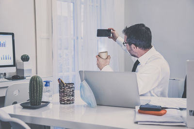 Business man working in the office making video call. male sitting at the desk works with laptop 