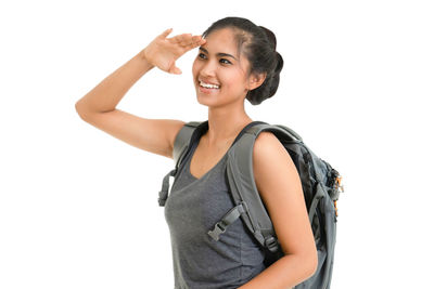 Portrait of a smiling young woman against white background