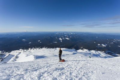 A man climbs to the summit of mt. hood in oregon.