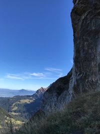 Scenic view of mountains against blue sky