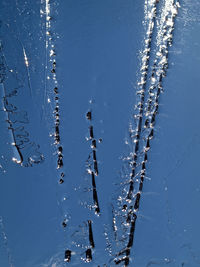 Close-up of frozen water against sky