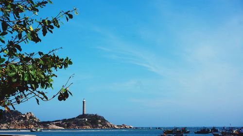 Low angle view of sea against blue sky