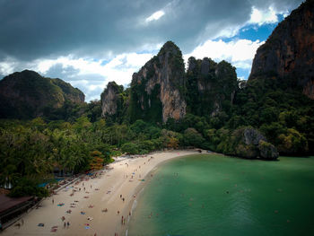 Scenic view of sea and mountains against sky