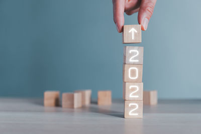 Cropped hand with toy blocks with text on wooden block