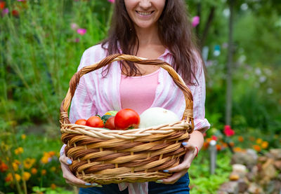 Portrait of young woman holding wicker basket