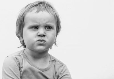 Close-up of boy against white background