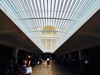 People walking on railroad station platform