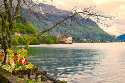 Scenic view of lake by mountain against sky