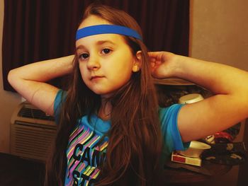 Portrait of girl wearing headband at home