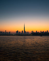 Buildings in city at sunset