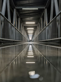 Empty corridor along railings