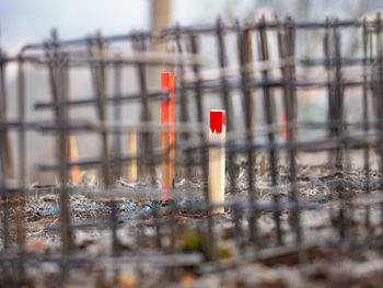 Red flag on building seen through fence