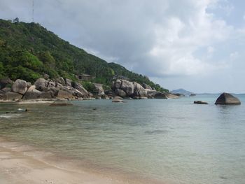 Scenic view of sea and mountains against sky