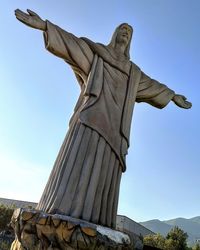 Low angle view of statue against sky