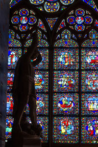 Low angle view of multi colored glass window of building