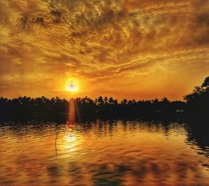 Scenic view of lake against sky during sunset