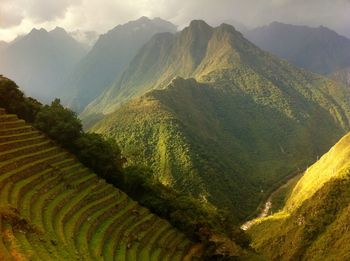 Scenic view of mountains against cloudy sky