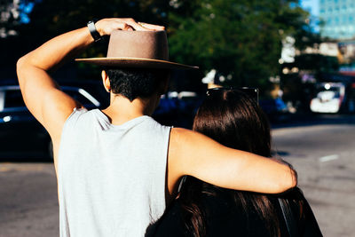 Rear view of man holding camera