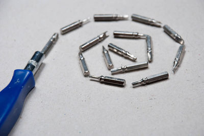 High angle view of screwdriver with work tools on table