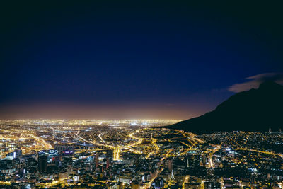 Aerial view of illuminated cityscape at night