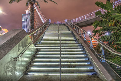 Low angle view of illuminated staircase in building at night