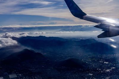 Aerial view of sea and mountains against sky