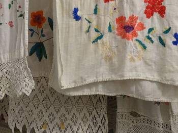 Close-up of white curtain hanging on bed