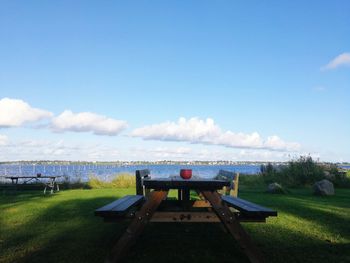 Lifeguard hut on field against sky