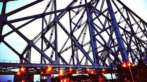 Low angle view of suspension bridge against sky