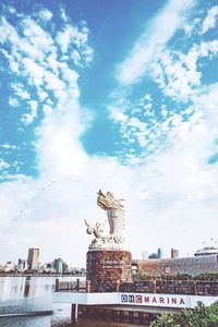 Low angle view of statue against cloudy sky