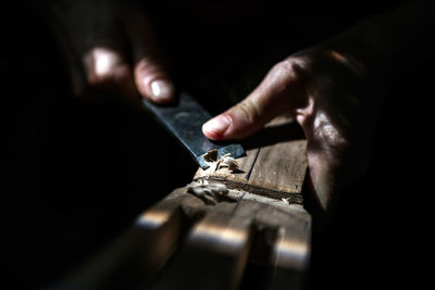 Unrecognized luthier woman in traditional workshop