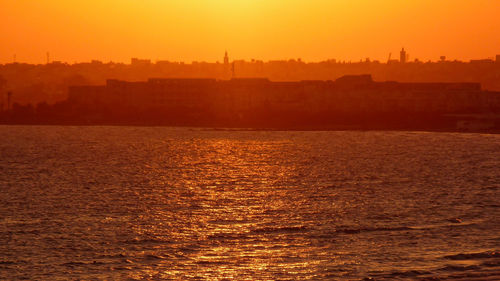 Scenic view of sea against clear sky during sunset