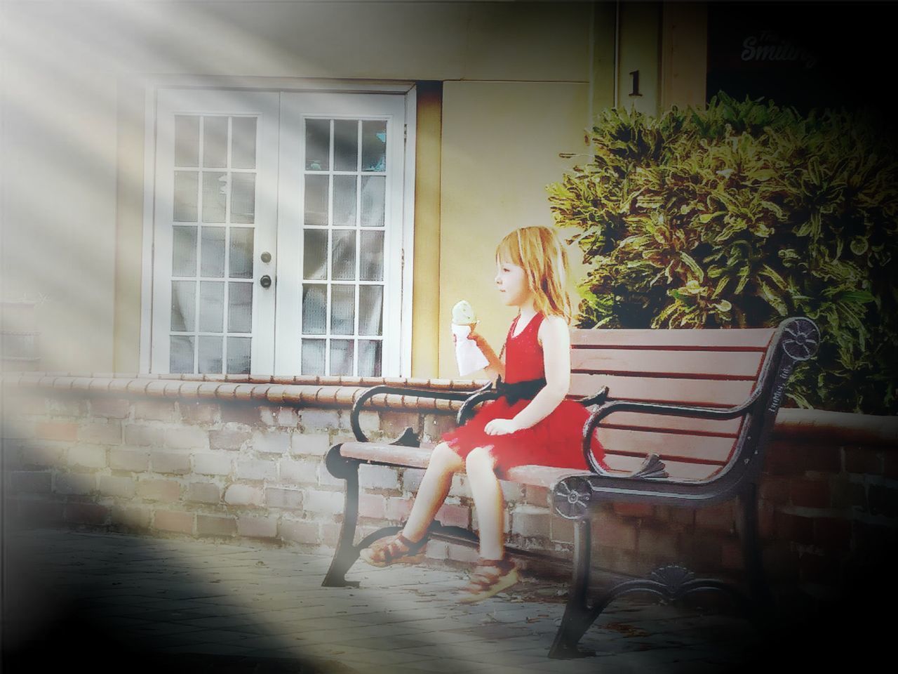 WOMAN SITTING ON SEAT BY WINDOW