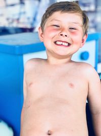 Portrait of happy boy with swimming pool