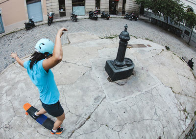 High angle view of woman skateboarding on street