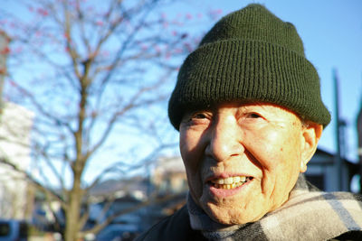 Close-up portrait of smiling man wearing hat