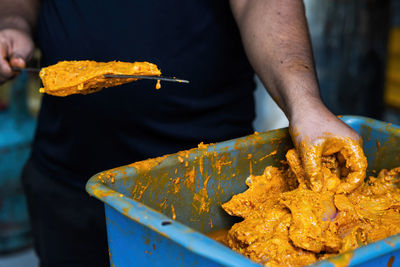 Midsection of man preparing food