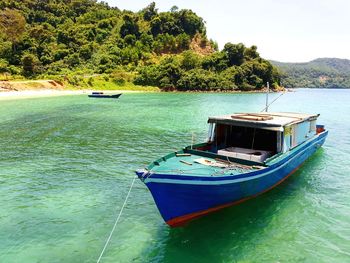 Boat moored on sea against sky