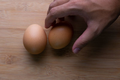 Close-up of hand holding bread on table