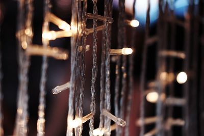 Close-up of icicles hanging on metal during winter